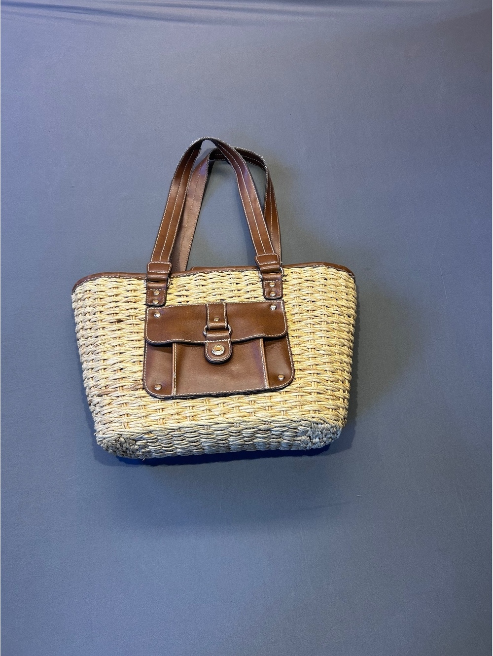 Woven straw tote bag with brown faux leather trim